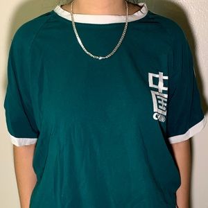 thrifted green top with china icon written on it